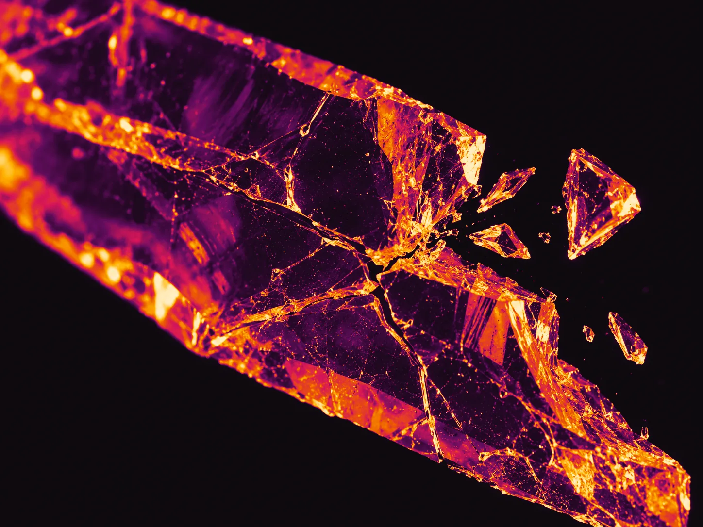 Illustrative photograph: a branching crystal fracture with sharp fragments frozen in mid-air
