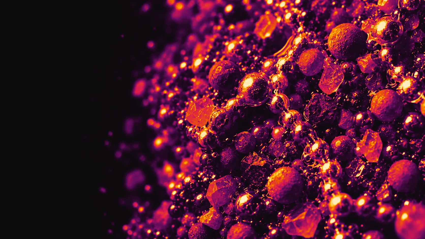 Illustrative photograph: a dense bed of metal and ceramic grains, glowing amber and crimson like a thermal image