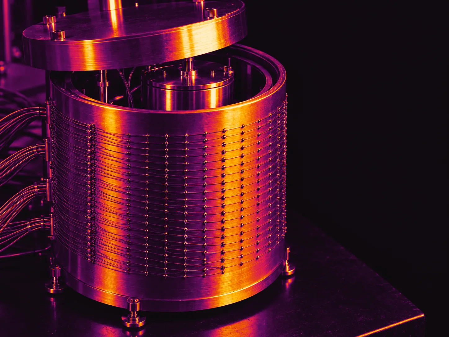 Illustrative image: a cylindrical aluminum calorimeter can wrapped in rows of thermocouple wire, lid lifted.